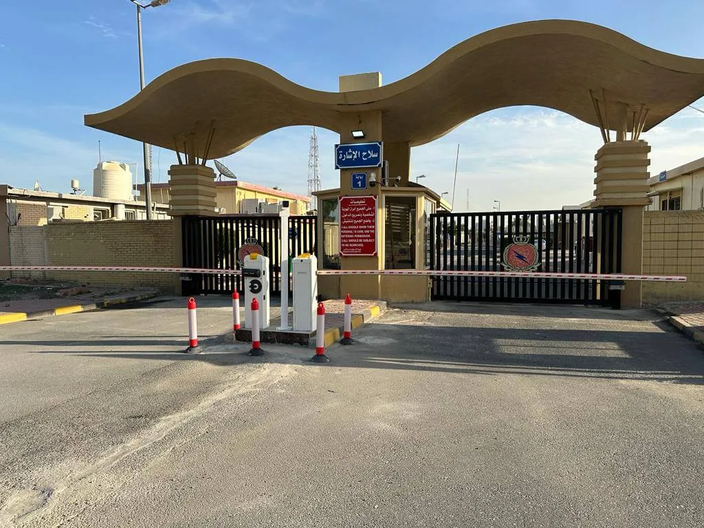 Boom barriers controlling a facility gate