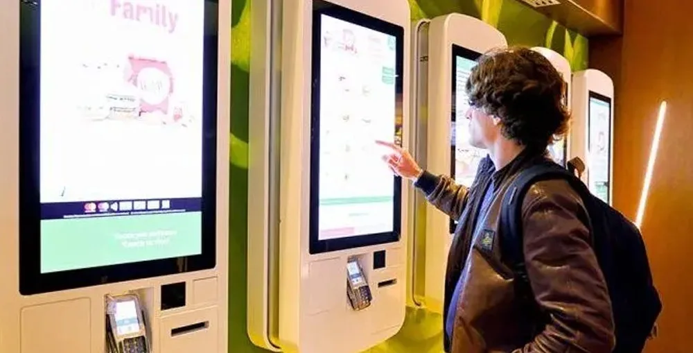 Visitor buying a ticket at a self-service kiosk